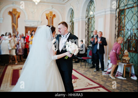 First wedding dance of waltz at hall of registration their marriage. Stock Photo