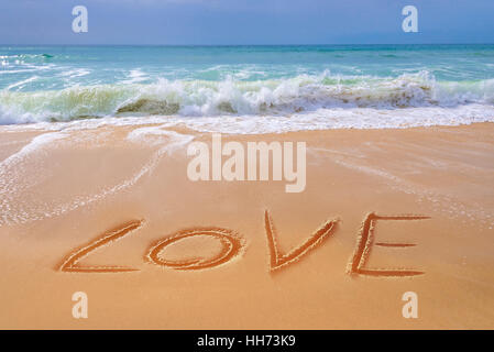 LOVE written on the sand of a beach, Saint Valentin and travel concept Stock Photo