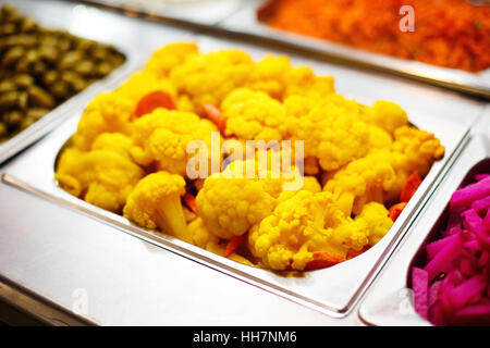 Cooked color yellow cauliflower in metallic dish. Street healthy food.