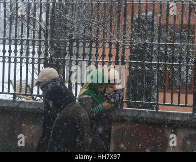 Srinagar, Indian Administered Kashmir. 17th January 2017. kashmiri people walking ,during snow continous on third condecutive day.Night temperature across Kashmir division went down with most places in the Valley receiving fresh snowfall overnight, while the Srinagar—Jammu national highway remained closed for vehicular traffic for the third day consecutive day today. ©Sofi Suhail/Alamy Live News Stock Photo