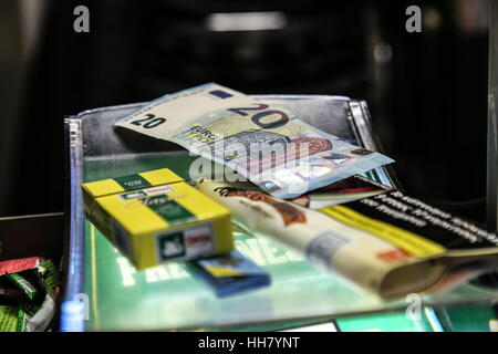 Athens, Greece. 13th Jan, 2017. A client has just paid for tobacco products at a kiosk in Athens, Greece, on Jan. 13, 2017. A barrage of new direct and indirect taxes on basic products and services went into effect on Jan. 1 in Greece, adding a further burden to debt-ridden households and enterprises. Credit: Lefteris Partsalis/Xinhua/Alamy Live News Stock Photo