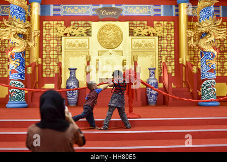 Kuala Lumpur, MALAYSIA. 16th Jan, 2017. Malaysian boys play boxing while a mother take a photo with Lunar New Year decorations at the Curve shopping mall in Kuala Lumpur, Malaysia on January 16, 2017. Credit: Chris Jung/ZUMA Wire/Alamy Live News Stock Photo