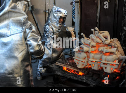 Burbank, USA. 17th Jan, 2017. Workers prepare to take molds out of a furnace during the production process of casting the bronze statuettes for the 23rd annual Screen Actors Guild (SAG) Awards. The statuettes, known as 'The Actor', were originally designed by Jim Heimann and Jim Barrett, and sculpted by Edward Saenz. Since the 1st SAG Awards in 1995, the statuettes have been produced by the American Fine Arts Foundry in Burbank. Credit: Xinhua/Alamy Live News Stock Photo