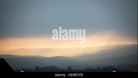 Yorkshire, UK. 18th Jan, 2017. Light breaks through the low cloud over Brighouse in West Yorkshire UK at dawn on Wednesday morning Credit: Windmill Images/Alamy Live News Stock Photo