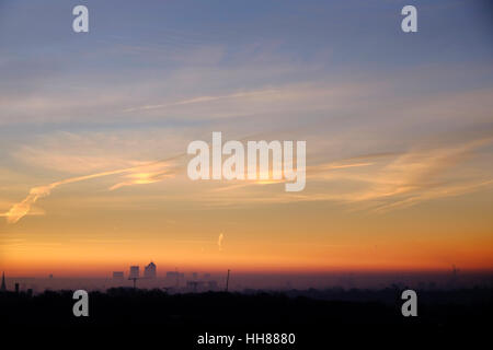London, UK 18 January 2017. Canary Wharf was bathed in a golden glow at sunrise today in what was a frosty start in the capital. Credit: Paul Swinney/Alamy Live News Stock Photo