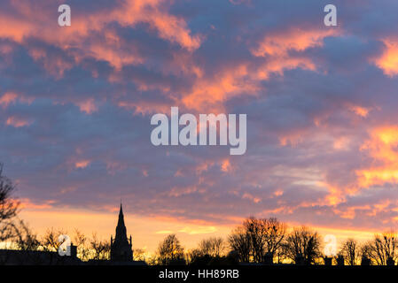 Willingham Cambridgeshire UK, 18th January 2017. A colourful sky as the sun sets behind the steeple of the church of St Mary and All Saints on a cold winter evening. Credit Julian Eales/Alamy Live News Stock Photo