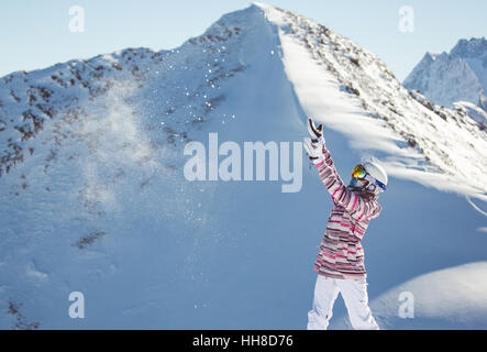 Female snowboarder in the alpine mountains Stock Photo