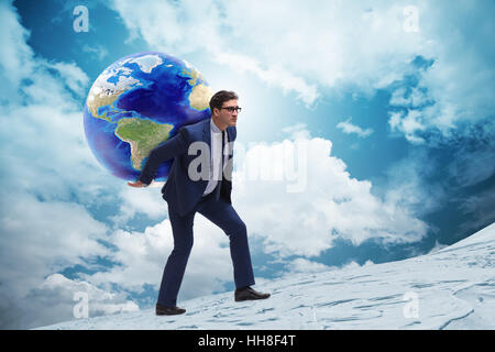 Businessman carrying Earth on his shoulders Stock Photo