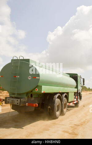 Green truck crane rolling in road works link Mombassa to Nairobi Stock Photo