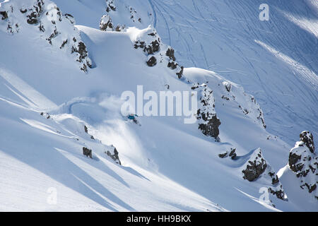 Backcountry snowboarder making a turn down the peak of Mount Olympus on the south island of New Zealand Stock Photo