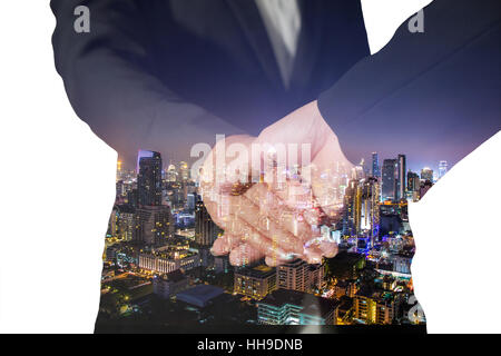 Double exposure of handshake and night city on white background Stock Photo