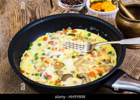 Omelet with vegetables in a pan Stock Photo