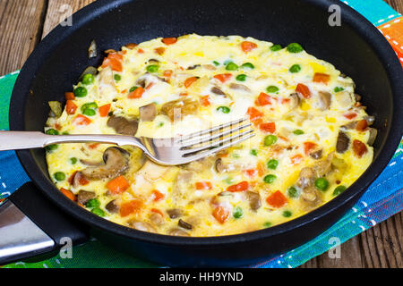 Omelet with vegetables in a pan Stock Photo