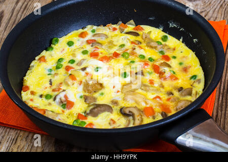 Omelet with vegetables in a pan Stock Photo