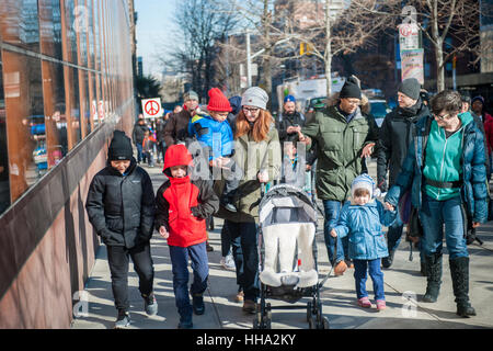 Students from the Manhattan Country School with their families and friends participate in their 29th Annual Martin Luther King Jr. Commemorative Walk in New York, organized by the 8th Grade students, on Monday, January 16, 2017.  The walkers honored the memory of King in their march through the Morningside Heights and Harlem stopping at various sites to read speeches and letters written by students.  (© Richard B. Levine) Stock Photo