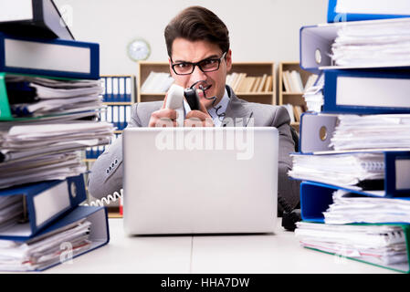 Busy businessman under stress due to excessive work Stock Photo