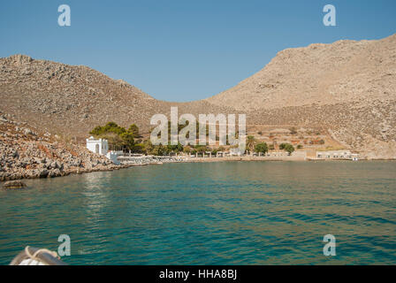 The beach and taverna at Agia Marina on the island of Symi Greece. Stock Photo