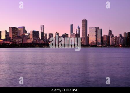 The late afternoon's setting sun reflecting off  a portion of the Chicago skyline beyond Grant Park in late autumn. Chicago, Illinois, USA. Stock Photo