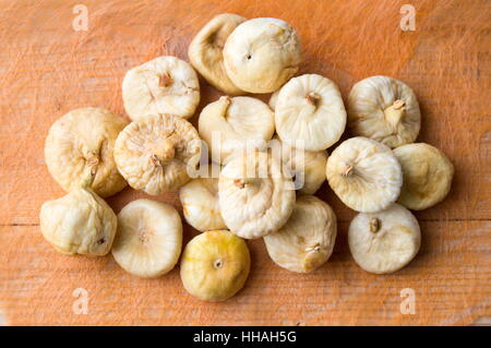 Bunch of dry figs on orange background Stock Photo