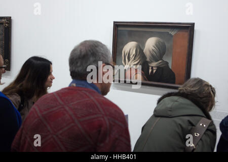 Visitors in front of the painting Les Amants (The Lovers, 1928) by Belgian surrealist artist Rene Magritte displayed at his retrospective exhibition in the Centre Pompidou in Paris, France. The exhibition entitled 'Rene Magritte. The Treachery of Images' runs till 23 January 2017. After that the reformulated version of the exhibition will be presented at the Schirn Kunsthalle in Frankfurt am Main, Germany, from 10 February to 5 June 2017. Stock Photo