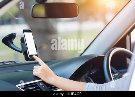 hand touching on phone mobile white screen in car Stock Photo