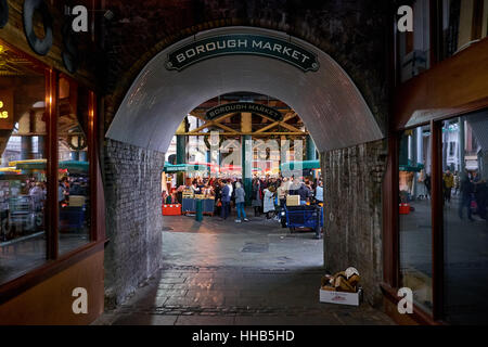 Entrance with hanging signs to Borough Market under the railway tracks near London Bridge Stock Photo