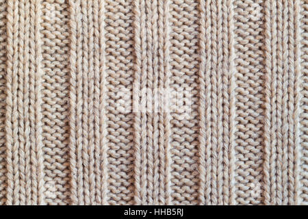 Creamy wool knitted warm clothes for the winter fabric texture background Stock Photo