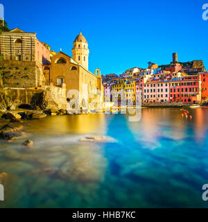 Vernazza village, church, rocks and sea harbor on sunset, Seascape in Five lands, Cinque Terre National Park, Liguria Italy Europe. Long Exposure. Stock Photo