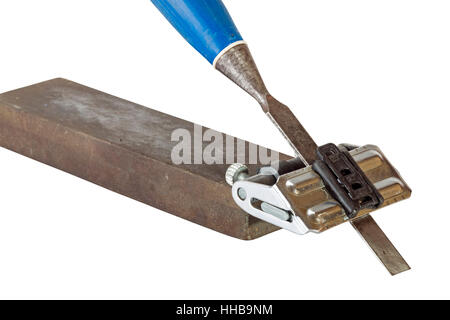 Close up studio shot of chisel clamped in angle guide jig resting on grinding whetstones on white background Stock Photo