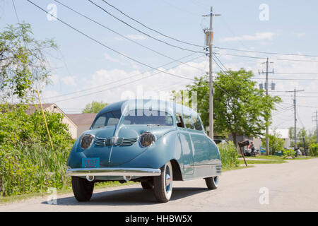 1936 Scarab minivan automobile, designed by William Stout, driving down a road. Stock Photo