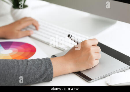 close up graphic design using digital pen tablet on desk workspace Stock Photo