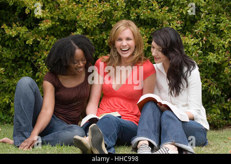 Diverse woman in a small group reading. Stock Photo