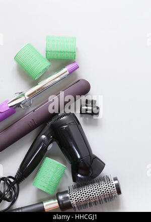 Set the tools hairdressers - hair dryer, curling iron, comb Stock Photo