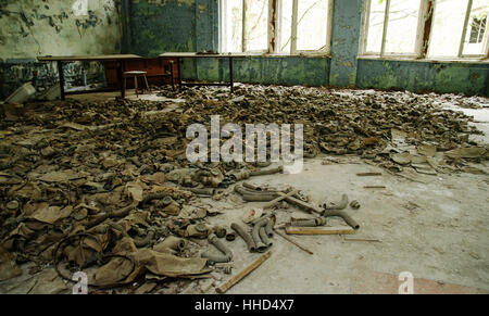 Infected radiation gas masks on the floor in an abandoned middle school in Chernobyl nuclear power plant zone of alienation Stock Photo