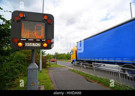 lorry passing flashing warning sign of 40mph reduced speed limit on M1 motorway due to roadworks near Leeds Yorkshire UK Stock Photo