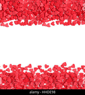 Horizontal seamless background with copy space, red hearts candy sprinkles isolated over white.