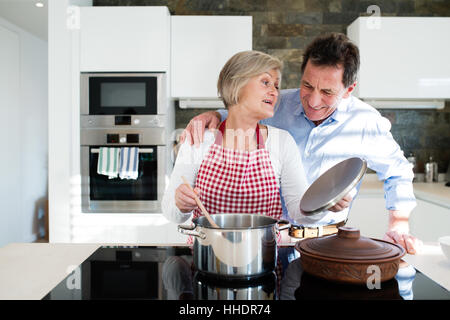 Senior couple in the kitchen cooking together. Stock Photo