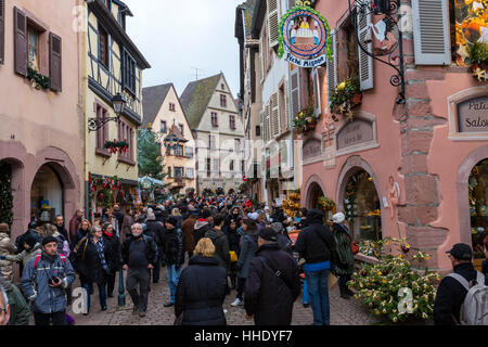 Tourists in the pedestrian road of the old town at Christmas time, Kaysersberg, Haut-Rhin department, Alsace, France Stock Photo