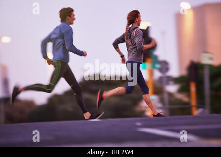 Runner couple running on urban city street Stock Photo