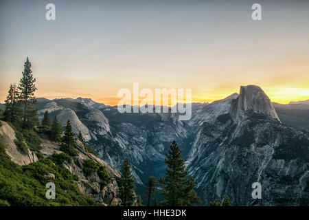 The mountain range in Yosemite valley at sunset, with distinct rock formations and snow covered slopes. Stock Photo