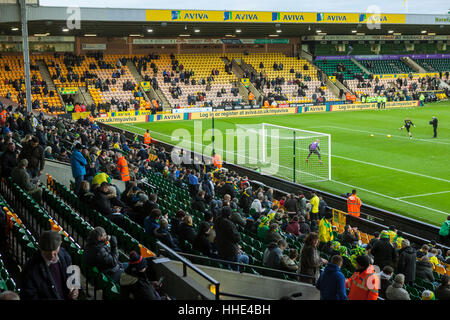 Norwich FC vs Brentford FC football match at Carrow Road Stadium. Fans arriving and watching the players warm up. Stock Photo