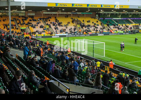 Norwich FC vs Brentford FC football match at Carrow Road Stadium. Fans arriving and watching the players warm up. Stock Photo