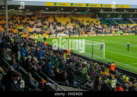 Norwich FC vs Brentford FC football match at Carrow Road Stadium. Fans arriving and watching the players warm up. Stock Photo