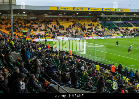 Norwich FC vs Brentford FC football match at Carrow Road Stadium. Fans arriving and watching the players warm up. Stock Photo