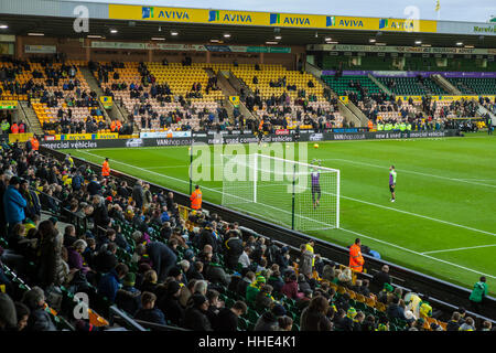 Norwich FC vs Brentford FC football match at Carrow Road Stadium. Fans arriving and watching the players warm up. Stock Photo