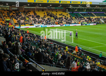 Norwich FC vs Brentford FC football match at Carrow Road Stadium. Fans arriving and watching the players warm up. Stock Photo