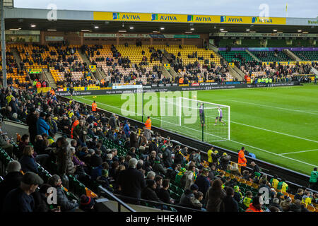 Norwich FC vs Brentford FC football match at Carrow Road Stadium. Fans arriving and watching the players warm up. Stock Photo