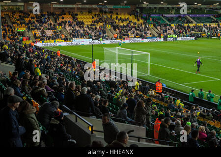 Norwich FC vs Brentford FC football match at Carrow Road Stadium. Fans arriving and watching the players warm up. Stock Photo