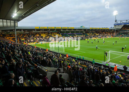 Norwich FC vs Brentford FC football match at Carrow Road Stadium. Fans arriving and watching the players warm up. Stock Photo