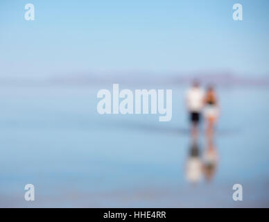 Blurred focus image of two people standing on flooded Bonneville Salt Flats, Utah Stock Photo